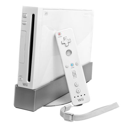 The white wii console turned a little bit to the left towards the viewer with its white rectangle remote